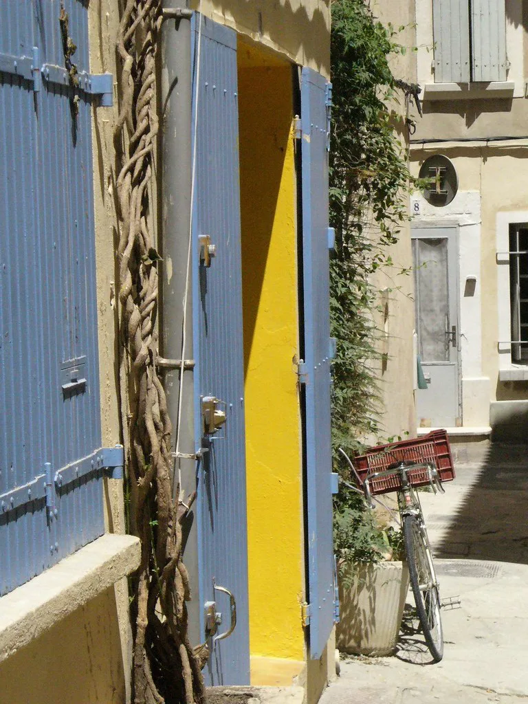 A bicycle parked on a quiet cobbled street in Arles, ideal for exploring the flat surrounding countryside