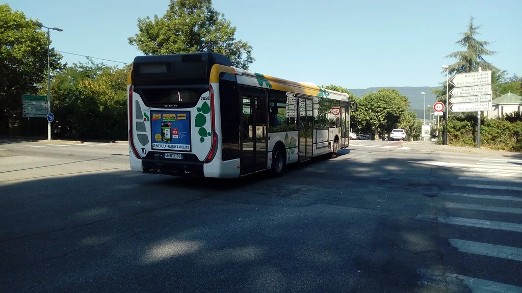 An urban transit bus on a Chambéry city street, part of the Synchro Mobilités network