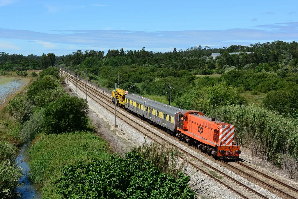A CP regional train at a railway station serving Coimbra, Portugal