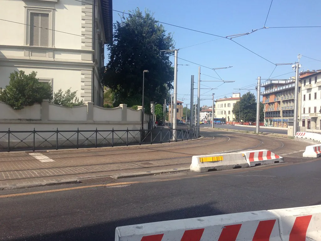 Florence tram tracks and overhead catenary lines along a city street