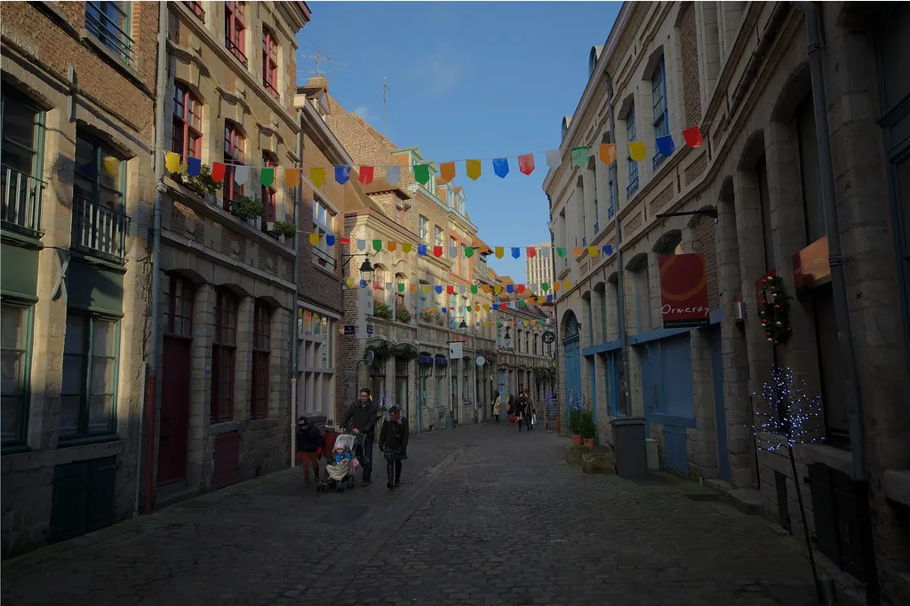 A historic cobblestone street lined with old townhouses in pedestrian-friendly Vieux Lille