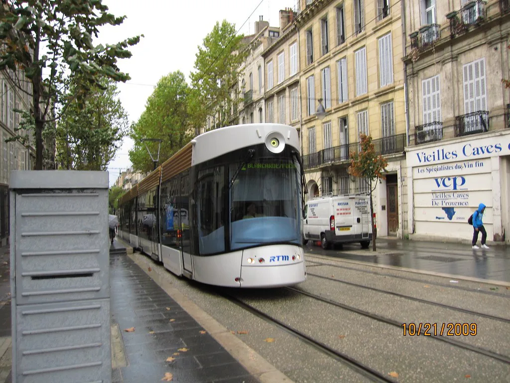 A modern Marseille tramway car running through the city streets