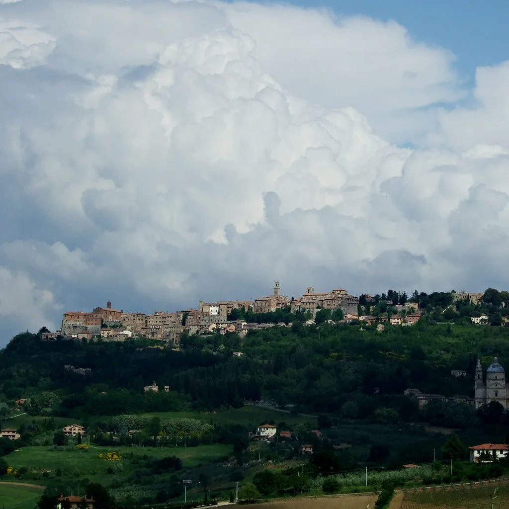 A medieval stone gateway into Montepulciano's walled center, where ZTL cameras enforce the Limited Traffic Zone