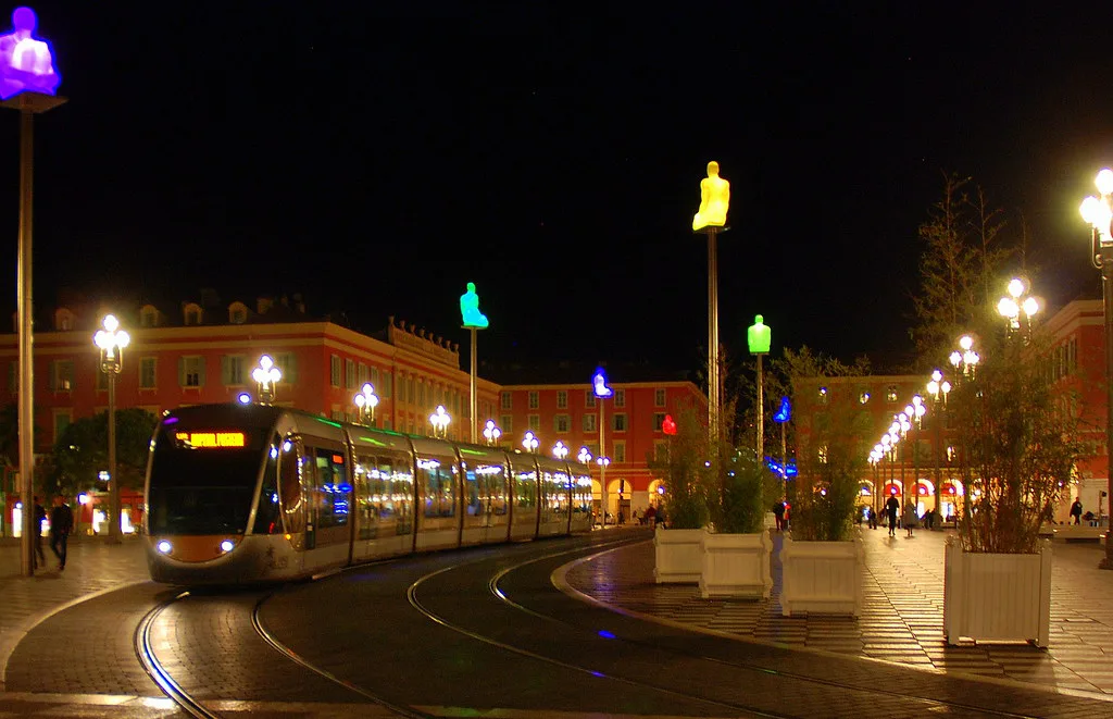 A Nice tram passing through Place Masséna at night along its city-center route