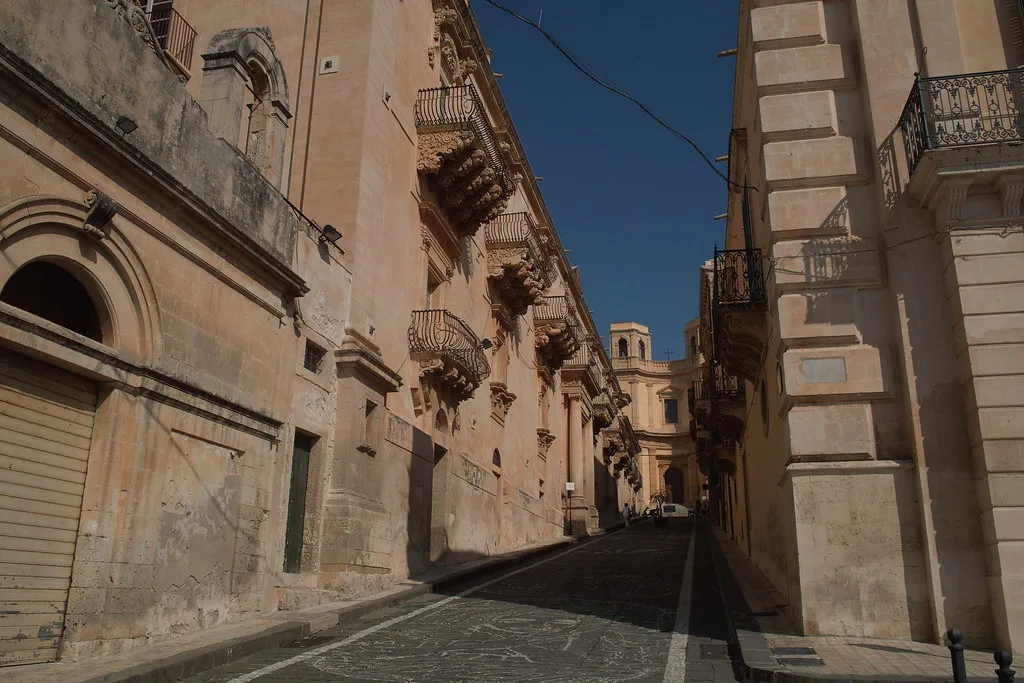 A narrow historic street in the centre of Noto, Sicily, the kind of restricted ZTL lane drivers must avoid