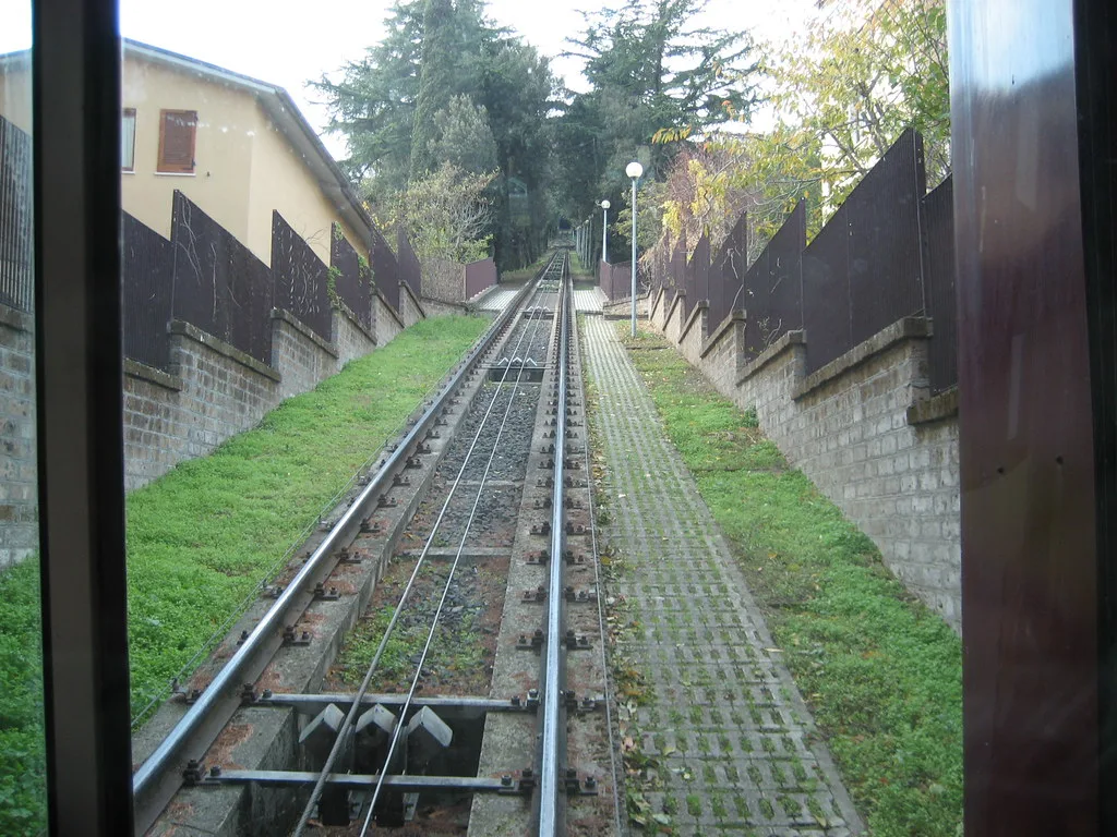 View from inside Orvieto's funicular climbing the steep cliffside from the train station