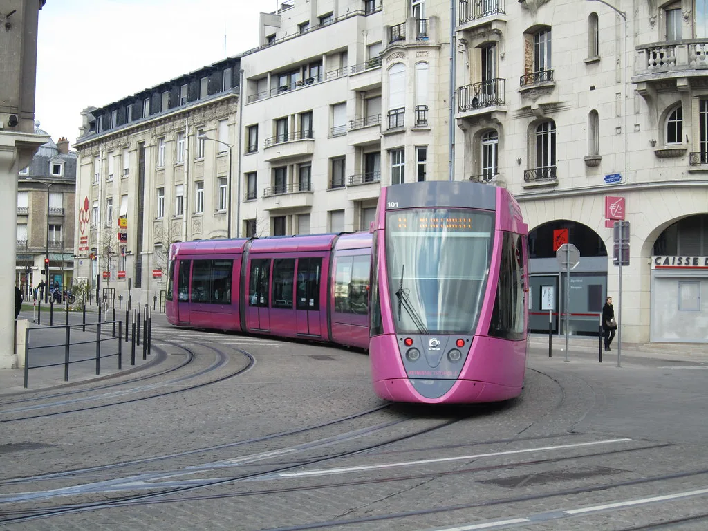 A CITURA tram gliding through a tree-lined boulevard in Reims