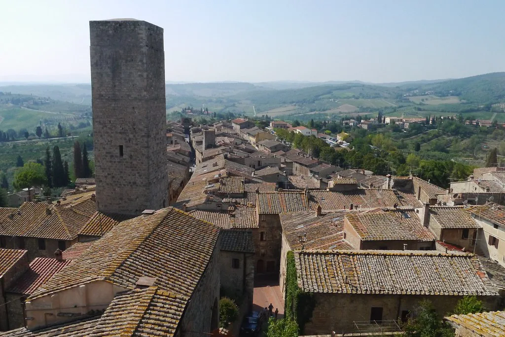 The medieval stone towers of San Gimignano rising above the surrounding Tuscan countryside