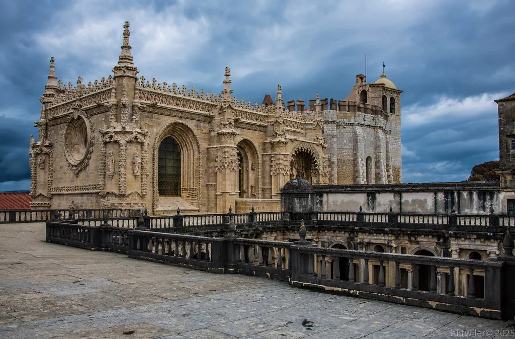 The hilltop Knights Templar castle and Convent of Christ rising above the rooftops of Tomar's old town