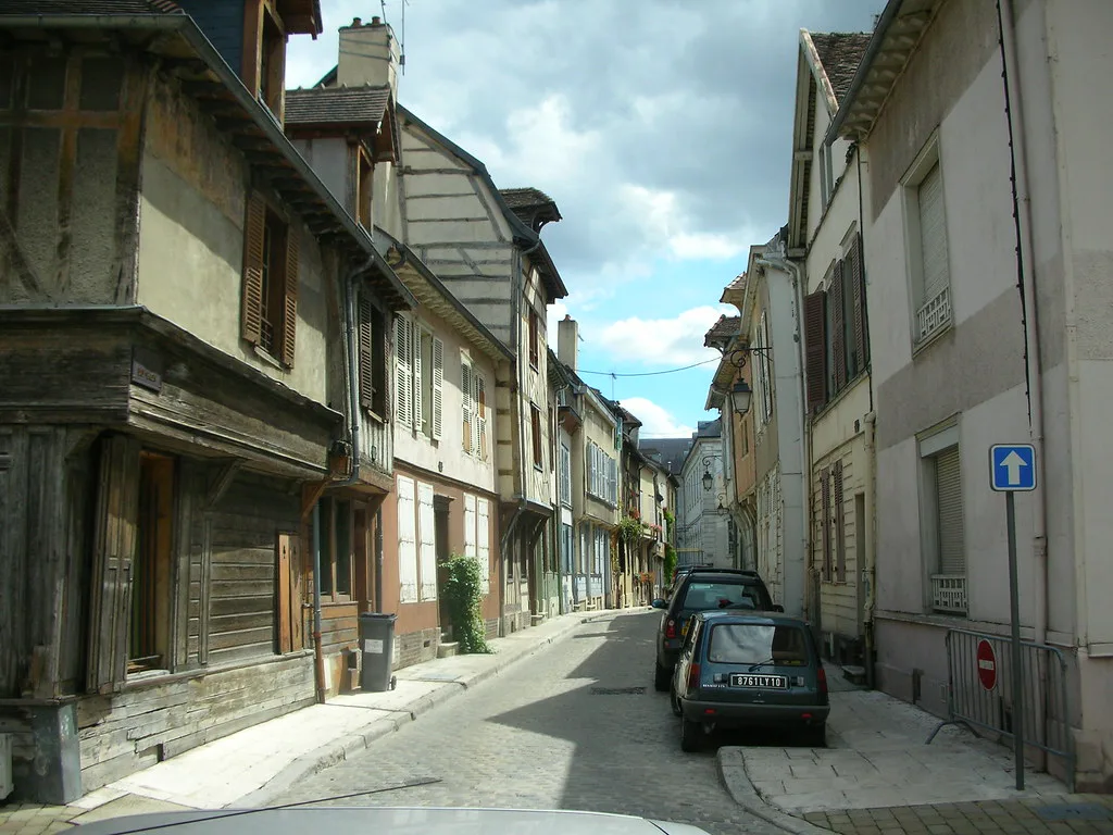 A narrow cobbled street lined with half-timbered houses in central Troyes, France