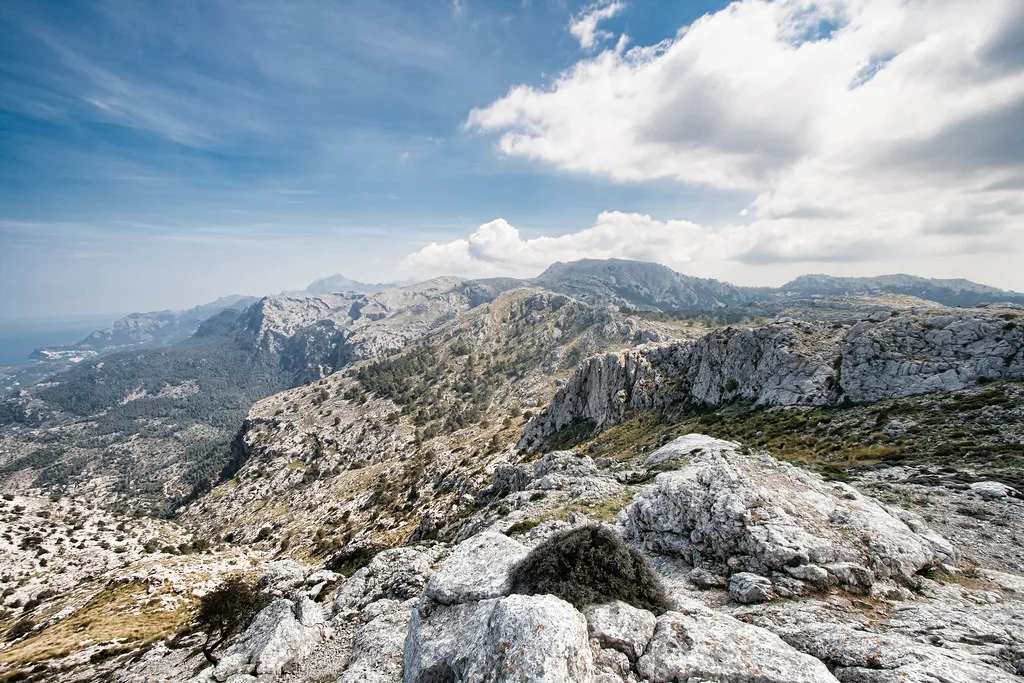 Valldemossa village set against the wooded peaks of the Serra de Tramuntana mountains in Mallorca