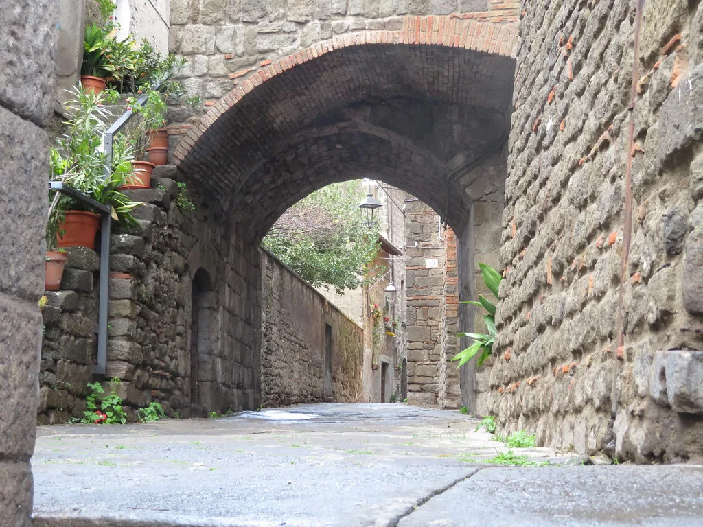 A narrow medieval street in Viterbo's San Pellegrino quarter inside the ZTL limited-traffic zone