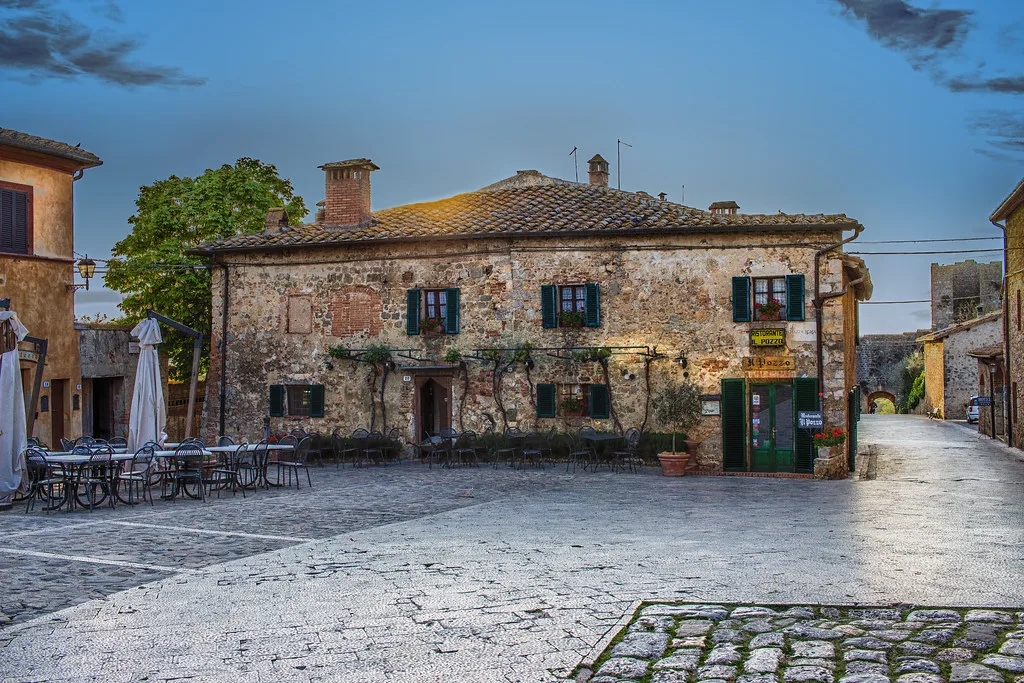 A historic stone gate and medieval walls marking the edge of Volterra's restricted ZTL zone